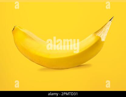 Banana-pencil merge creative concept on yellow background Stock Photo
