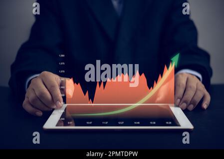 financial charts and graph analysis marketing showing growing revenue digital screen tablet, business about strategy for growth and success. Stock Photo