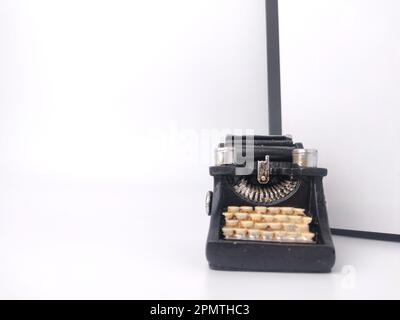 Black vintage typewritter on a white background. Stock Photo