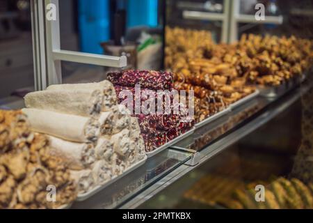 Traditional oriental sweet pastry cookies, nuts, dried fruits, pastilles, marmalade, Turkish desert with sugar, honey and pistachio, in display at a Stock Photo