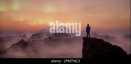 Adventure Man on top of Rocky Mountain Landscape. Stock Photo