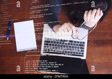 Programmer working on laptop computer and coding code on screen. Internet and technology Stock Photo