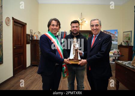 Pagani, Salerno, Italy - April 14, 2023 : Seen the Senator, Maurizio Gasparri, to the Municipality of Pagani to attend the opening of the doors of the Sanctuary of the Madonna delle Galline, an ancient feast held on Sunday after Easter. To welcome him in Pagani on April 14, 2023, the Mayor of the city, Lawyer Raffaele Maria De Prisco. In memory of the feast was offered to the Vice President of the Senate, Maurizio Gasparri, a small statue depicting the image of the Madonna delle Galline, created by the pagan artist, Maestro Alfonso Pepe.In the photo Maurizio Gasparri (right) receives the Stock Photo