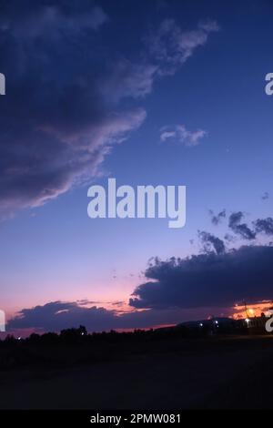 A blue sky with a few clouds in it Stock Photo