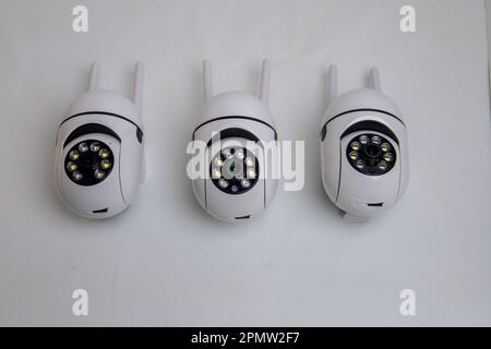 Rotating video surveillance camera on a white background. Stock Photo