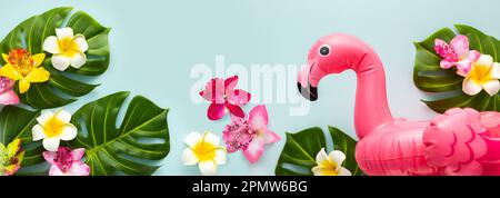 Pink flamingo, tropical leaf monstera and orchid flowers on light background. Summer beach party concept. Flat lay, copy space. Stock Photo