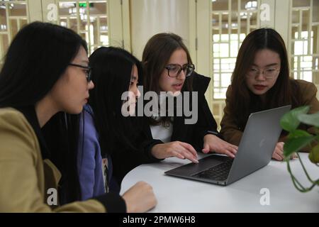 (230415) -- BEIJING, April 15, 2023 (Xinhua) -- Maria (2nd R) talks with schoolmates at the Yenching Academy of Peking University in Beijing, capital of China, April 13, 2023. Maria Eduarda Variani, Rafaela Viana dos Santos, Manuela Boiteux Pestana, and Marco Andre Rocha Germano are Brazilian students studying in the Master of China Studies program at the Yenching Academy of Peking University in China. The four of them have been interested in Chinese culture since they were young. After arriving in Beijing, they have been impressed by the Chinese capital's profound cultural heritage, conve Stock Photo