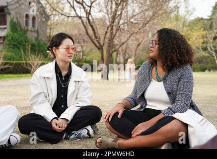 (230415) -- BEIJING, April 15, 2023 (Xinhua) -- Rafaela (R) chats with a schoolmate at Peking University in Beijing, capital of China, March 31, 2023. Maria Eduarda Variani, Rafaela Viana dos Santos, Manuela Boiteux Pestana, and Marco Andre Rocha Germano are Brazilian students studying in the Master of China Studies program at the Yenching Academy of Peking University in China. The four of them have been interested in Chinese culture since they were young. After arriving in Beijing, they have been impressed by the Chinese capital's profound cultural heritage, convenient public services, an Stock Photo