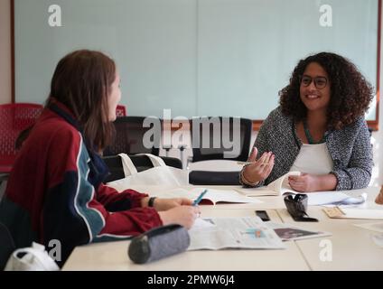 (230415) -- BEIJING, April 15, 2023 (Xinhua) -- Rafaela (R) and Maria talk at a classroom at the Yenching Academy of Peking University in Beijing, capital of China, March 31, 2023. Maria Eduarda Variani, Rafaela Viana dos Santos, Manuela Boiteux Pestana, and Marco Andre Rocha Germano are Brazilian students studying in the Master of China Studies program at the Yenching Academy of Peking University in China. The four of them have been interested in Chinese culture since they were young. After arriving in Beijing, they have been impressed by the Chinese capital's profound cultural heritage, Stock Photo