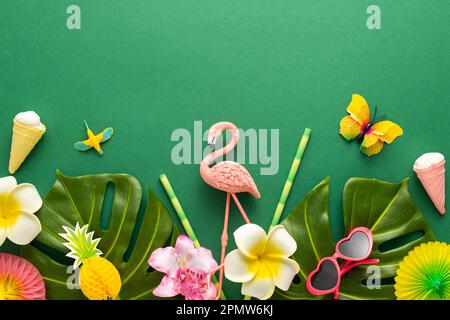 Exotic tropical summer background. Summer beach party concept. Pink flamingo, tropical leaves, orchid flowers and other accessories on green backgroun Stock Photo