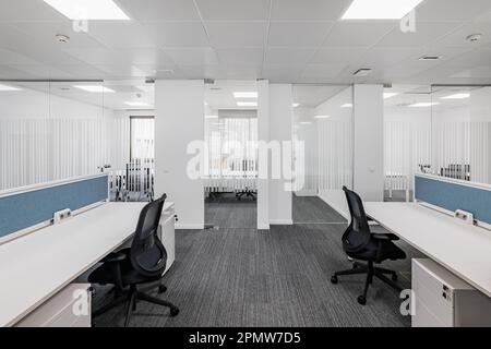 An empty office in solid colors with comfortable office furniture without equipment is ready to receive employees. The concept of a modern corporate Stock Photo