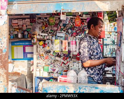 Small, streetside pharmacy selling medication and condoms in downtown Dhaka, the capital of Bangladesh. Stock Photo