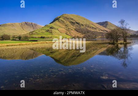 Looking across Brothers Water in the Lake District towards Hartsop Dodd which is reflected in the lake. Stock Photo