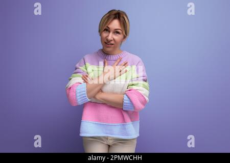 cute shy blondie young woman on purple background with copy space Stock Photo