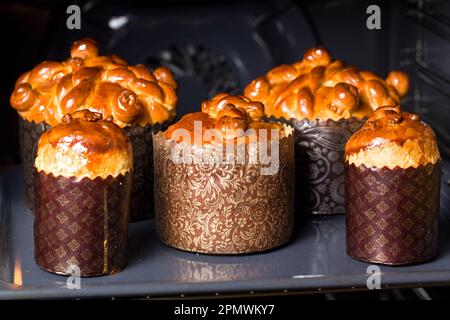 Easter cake. Freshly baked Easter pies in a hot oven in a special paper baking form Stock Photo