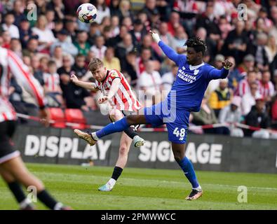 Sheffield, UK. 15th Apr, 2023. Tommy Doyle of Sheffield Utd (L) is challenged by Sory Kaba of Cardiff City during the Sky Bet Championship match at Bramall Lane, Sheffield. Picture credit should read: Andrew Yates/Sportimage Credit: Sportimage/Alamy Live News Stock Photo