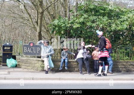 Member of Britannia Coconutters selling souvenirs to spectators during the annual perambulation of the town of Bacup in Lancashire on Easter Saturday Stock Photo