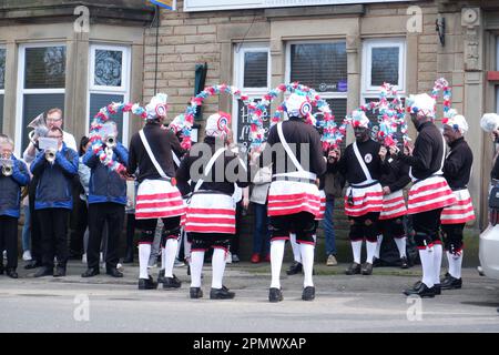 The Britannia Coconutters perform their annual perambulation of the town of Bacup in Lancashire outside the George & Dragon pub on Easter Saturday Stock Photo