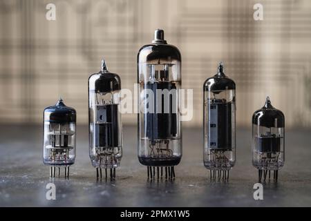 Old diode lamps of different sizes on a table, close up. Several different vacuum tubes for old radio and TV Stock Photo