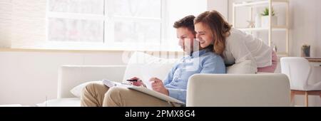 Happy Family Using Calculator For Tax And Budget Stock Photo