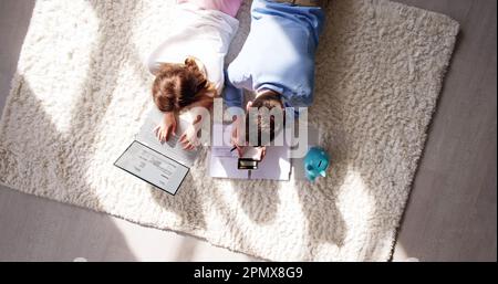 Young Couple Calculating Finance Tax Using Calculator Stock Photo