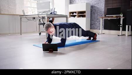 Man Doing Office Plank Exercise Workout Training Stock Photo