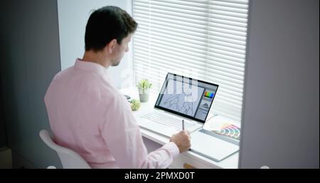 Male Designer Using Graphic Tablet While Working On Computer Stock Photo