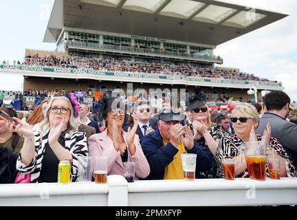 Racegoers take part in a minutes applause on the anniversary of the Hillsborough disaster on day three of the Randox Grand National Festival at Aintree Racecourse, Liverpool. Picture date: Saturday April 15, 2023. Stock Photo