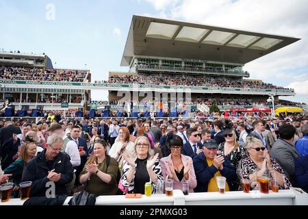 Racegoers take part in a minutes applause on the anniversary of the Hillsborough disaster on day three of the Randox Grand National Festival at Aintree Racecourse, Liverpool. Picture date: Saturday April 15, 2023. Stock Photo