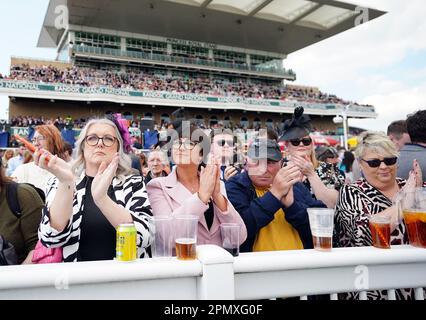 Racegoers take part in a minutes applause on the anniversary of the Hillsborough disaster on day three of the Randox Grand National Festival at Aintree Racecourse, Liverpool. Picture date: Saturday April 15, 2023. Stock Photo