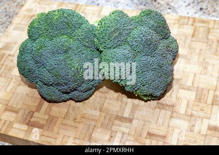 Two broccoli cut out on a wooden board Stock Photo