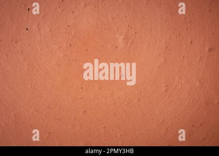 close-up of earthenware surface, full frame background, red handmade clay pottery or terra cotta porous texture, soft focus with copy space Stock Photo