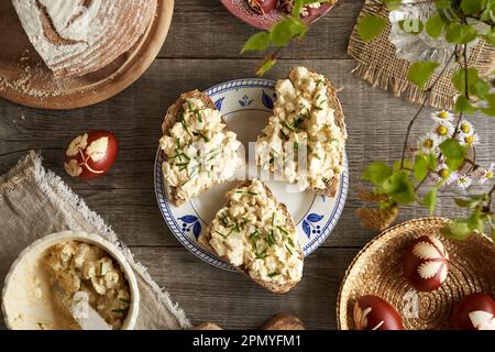 Bread spread made of leftover hard-boiled Easter eggs, mustard and cottage cheese on three slices, top view Stock Photo
