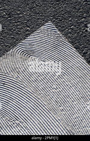 geometrical white painting of pedestrian crossing with texture on asphalt Stock Photo