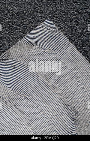 geometrical white painting of pedestrian crossing with texture on asphalt Stock Photo
