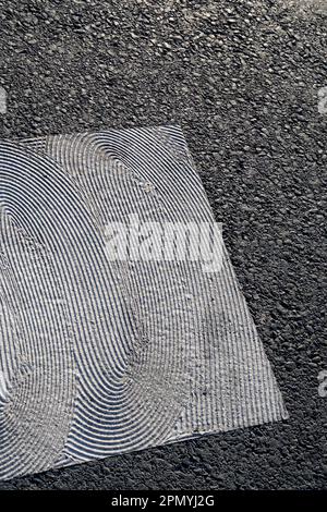 geometrical white painting of pedestrian crossing with texture on asphalt Stock Photo