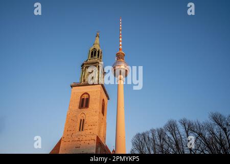 St. Mary Church and TV Tower (Fernsehturm) at sunset - Berlin, Germany Stock Photo