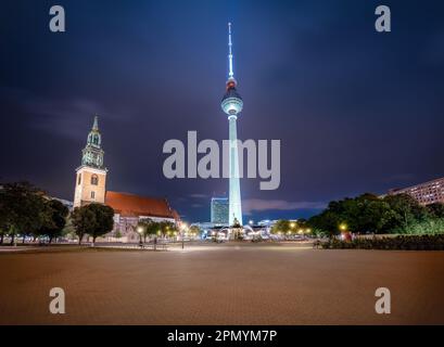 TV Tower (Fernsehturm) and St. Mary Church at night - Berlin, Germany Stock Photo