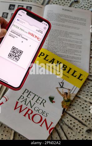 Playbills and Tickets on iPhone, Peter Pan Goes Wrong, 2023, NYC, USA Stock Photo