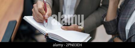 Close up of Businessman standing in office and making notes Stock Photo