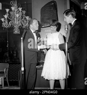 File photo dated 26/04/62 of the award for the Best British Dramatic Screenplay in 1961, given to Shelagh Delaney and Tony Richardson for the film 'A Taste of Honey', being accepted on their behalf by Rita Tushingham and Murray Melvin from Richard Attenborough (left) at the first annual awards dinner of the Television and Screen Writers' Guild at the Dorchester Hotel. London. Torchwood actor Murray Melvin's death on Friday was announced by a friend, who said the actor had 'never fully recovered' from a fall in December, before he died aged 90 . Issue date: Saturday April 15, 2023. Stock Photo