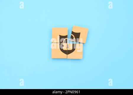Padlock icon on wooden cube with blue background, Privacy security Stock Photo
