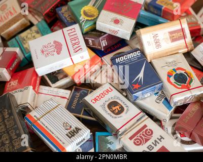 Soligorsk, Belarus - 3 September 2022: Soviet cigarette packs piled up in heap, selective focus. Retro cigarettes stored in pile Stock Photo