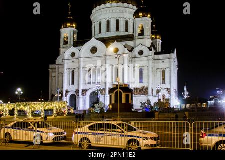 Moscow, Russia. 15th Apr, 2023. Police cars fence off the Cathedral of Christ the Savior from the crowd in Moscow. Orthodox Easter is celebrated on the night of April 16. A closed church service is being conducted on that night at the Cathedral of Christ the Savior in Moscow. Putin's press secretary announces that the Russian President will attend the ceremony in the cathedral. On the night of April 16, the ceremony was an invitation-only event. Credit: SOPA Images Limited/Alamy Live News Stock Photo