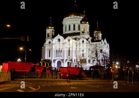 Moscow, Russia. 15th Apr, 2023. Trucks block the road near the Cathedral of Christ the Savior off from the crowd in Moscow. Orthodox Easter is celebrated on the night of April 16. A closed church service is being conducted on that night at the Cathedral of Christ the Savior in Moscow. Putin's press secretary announces that the Russian President will attend the ceremony in the cathedral. On the night of April 16, the ceremony was an invitation-only event. Credit: SOPA Images Limited/Alamy Live News Stock Photo