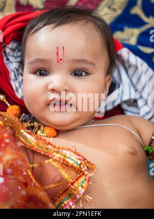 cute Indian boy dresses as lord rama with bow and flowers from top angle Stock Photo