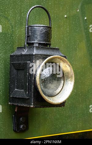 Old black railroad lamp on a steam engine Stock Photo