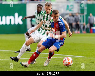 Mats Knoester of Ferencvarosi TC competes for the ball with