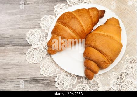 Croissants on a saucer with a napkin. Stock Photo