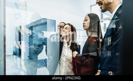 Multiracial creative team planning business market strategy inside boardroom office - Brainstorming and teamwork concept Stock Photo